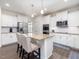 Kitchen featuring stainless steel appliances, white cabinets, granite counters, and a kitchen island at 182 Mill Bend Dr, Fuquay Varina, NC 27526