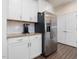 Kitchen featuring stainless steel appliances, white cabinets, granite counters, and large refrigerator at 182 Mill Bend Dr, Fuquay Varina, NC 27526