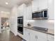Kitchen featuring stainless steel appliances, white cabinets, granite counters, and subway tile backsplash at 182 Mill Bend Dr, Fuquay Varina, NC 27526