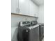 Laundry room showcasing front load washer and dryer, as well as white cabinets at 182 Mill Bend Dr, Fuquay Varina, NC 27526