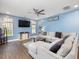 Bright living room featuring a ceiling fan, hardwood floors, and plenty of natural light at 182 Mill Bend Dr, Fuquay Varina, NC 27526