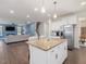 Open concept living with kitchen island, stainless steel appliances, and living area featuring sofa and TV at 182 Mill Bend Dr, Fuquay Varina, NC 27526