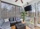 Relaxing screened-in porch with comfortable seating, ceiling fan, and wooded views at 182 Mill Bend Dr, Fuquay Varina, NC 27526