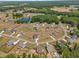 Picturesque aerial shot of a residential area, showcasing spacious lots and serene community setting with pond at 182 Prince Place Dr, Fuquay Varina, NC 27526