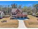 Expansive view of a two-story home with a three-car garage on a sprawling lot at 182 Prince Place Dr, Fuquay Varina, NC 27526