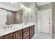Bathroom features walk-in shower, double vanity with white countertop, and contemporary fixtures at 182 Prince Place Dr, Fuquay Varina, NC 27526