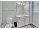 Bathroom with white cabinets, a large mirror, neutral walls, and gray floors create a clean, modern feel at 182 Prince Place Dr, Fuquay Varina, NC 27526