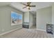 Comfortable bedroom featuring plush carpet, a ceiling fan, natural light, and closet for organized storage at 182 Prince Place Dr, Fuquay Varina, NC 27526