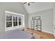Bright bedroom with vaulted ceiling, oversized window, plush carpeting, and ample closet space at 182 Prince Place Dr, Fuquay Varina, NC 27526
