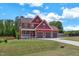 Attractive two-story home with a three-car garage and a lush green lawn at 182 Prince Place Dr, Fuquay Varina, NC 27526