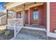 Close-up of the charming front porch with brick steps and a beautiful wood door at 182 Prince Place Dr, Fuquay Varina, NC 27526