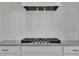 Kitchen features stainless steel gas range, granite countertops, white shaker cabinets, and white subway tile backsplash at 182 Prince Place Dr, Fuquay Varina, NC 27526