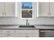 Kitchen features stainless steel appliances, black sink faucet, granite countertops, white shaker cabinets, and subway tile backsplash at 182 Prince Place Dr, Fuquay Varina, NC 27526