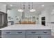 Open kitchen with a gray island, white cabinets, and view into the dining area at 182 Prince Place Dr, Fuquay Varina, NC 27526