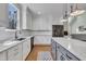 Modern kitchen featuring white cabinets, gray island, and stainless steel appliances at 182 Prince Place Dr, Fuquay Varina, NC 27526