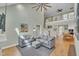 Bright living room features an open floor plan with dining area, staircase, and neutral color scheme at 182 Prince Place Dr, Fuquay Varina, NC 27526