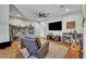 Comfortable living room featuring a ceiling fan, hardwood floors, and built-in shelving for storage and display at 182 Prince Place Dr, Fuquay Varina, NC 27526