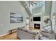Cozy living room with fireplace, high ceilings, light-colored walls, wood floors, and large picture windows at 182 Prince Place Dr, Fuquay Varina, NC 27526