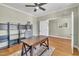 Home office featuring hardwood floors, a ceiling fan and shelving at 182 Prince Place Dr, Fuquay Varina, NC 27526