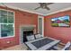 Covered porch with an inviting fireplace and outdoor furniture, perfect for relaxing and watching TV at 182 Prince Place Dr, Fuquay Varina, NC 27526
