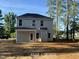 Backyard of a home featuring new sod and a covered porch, with large windows allowing in natural light at 187 Regis Ln # 10, Coats, NC 27521