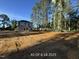 Backyard of a home featuring new sod and a covered porch. Tall trees provide natural shading at 187 Regis Ln # 10, Coats, NC 27521