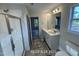 Bathroom featuring a double sink vanity, shower and toilet at 187 Regis Ln # 10, Coats, NC 27521