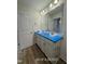 A clean bathroom features a double sink vanity and wood laminate flooring at 187 Regis Ln # 10, Coats, NC 27521