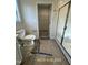 Bathroom featuring a toilet, shower and doorway to closet at 187 Regis Ln # 10, Coats, NC 27521