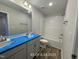 Bright bathroom featuring double sinks with laminate wood flooring and a shower-tub combo with white tiling at 187 Regis Ln # 10, Coats, NC 27521