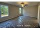 A spacious bedroom offers ample natural light through two large windows at 187 Regis Ln # 10, Coats, NC 27521