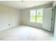 Unfinished bedroom with a window, and a blank walls and flooring ready for finishing touches at 187 Regis Ln # 10, Coats, NC 27521
