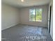 Bedroom with a large window offering natural light at 187 Regis Ln # 10, Coats, NC 27521