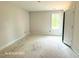 Bright bedroom featuring one window and a door at 187 Regis Ln # 10, Coats, NC 27521