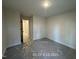 A simple bedroom with neutral walls and carpet at 187 Regis Ln # 10, Coats, NC 27521