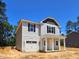 Charming two-story home with a covered porch and a one car garage at 187 Regis Ln # 10, Coats, NC 27521