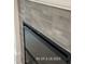 New fireplace features gray brick and a black door at 187 Regis Ln # 10, Coats, NC 27521