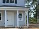 Close up of the charming house featuring a welcoming porch with white columns, and a white front door at 187 Regis Ln # 10, Coats, NC 27521