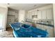 A kitchen featuring white cabinets, granite countertops and an island with a stainless steel sink at 187 Regis Ln # 10, Coats, NC 27521