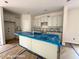 Spacious kitchen is ready for your customizations with white cabinets, an island and modern features at 187 Regis Ln # 10, Coats, NC 27521