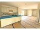 Open-concept kitchen and living area with white cabinets, kitchen island, and abundant natural light at 187 Regis Ln # 10, Coats, NC 27521