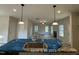 An open concept showcases the kitchen's pendant lights and view to living area at 187 Regis Ln # 10, Coats, NC 27521