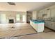 Open-concept kitchen featuring modern cabinetry, an island with sink, and a view into the adjacent living space at 187 Regis Ln # 10, Coats, NC 27521