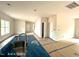 Bright living room under construction with a kitchen island with a stainless steel sink in the background at 187 Regis Ln # 10, Coats, NC 27521