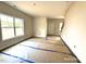 Bright, open living room featuring large windows, neutral paint, and a staircase leading to the upper level at 187 Regis Ln # 10, Coats, NC 27521
