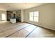 A spacious living room under construction with a kitchen island with a stainless steel sink in the background at 187 Regis Ln # 10, Coats, NC 27521