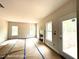 Inviting living room with a fireplace, multiple windows for ample natural light, and a door to the backyard at 187 Regis Ln # 10, Coats, NC 27521