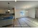 A bright and airy living room features a large window and chandelier at 187 Regis Ln # 10, Coats, NC 27521