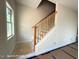 A stairway with a light wood railing, and walls painted white and a window at the top landing at 187 Regis Ln # 10, Coats, NC 27521
