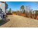 View of the home's backyard with a wood fence and lush foliage at 1950 Firenza Dr, Apex, NC 27502